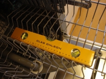 Sjekke om maskinens bakre og fremre ben er stilt riktig, at de er i vater